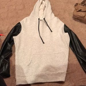 Cute gray sweatshirt with leather sleeves.